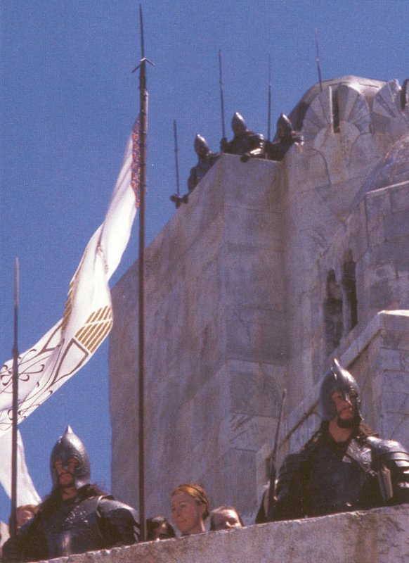 Gondorian Soldiers Stand Atop the Battlements - 582x800, 81kB